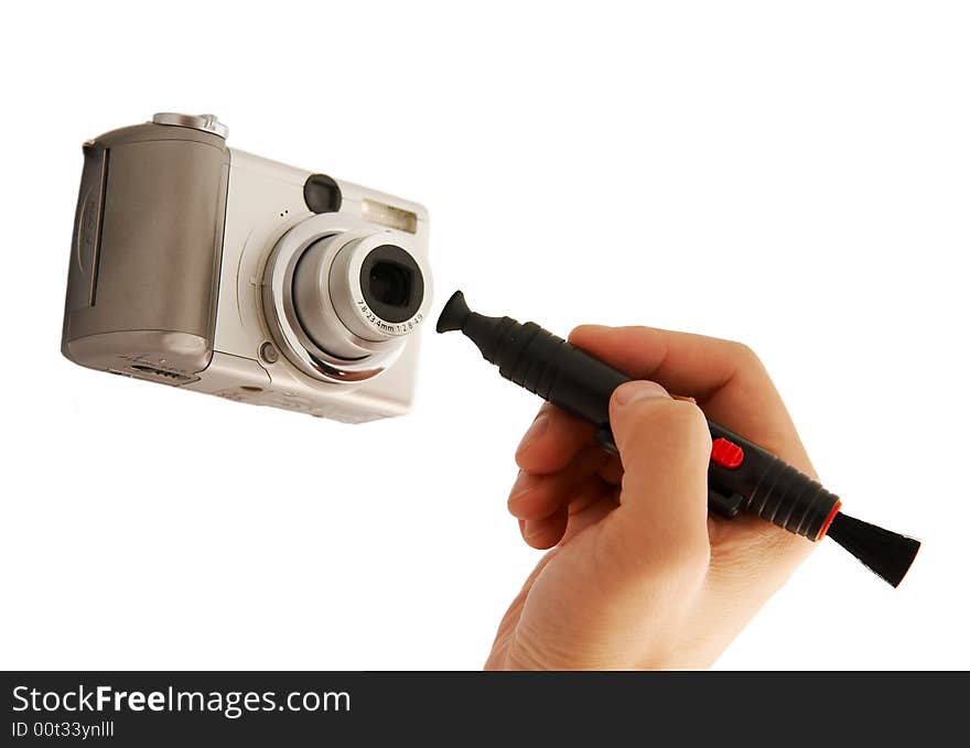 A hand cleaning a lens of camera with a tool,isolated on white. A hand cleaning a lens of camera with a tool,isolated on white