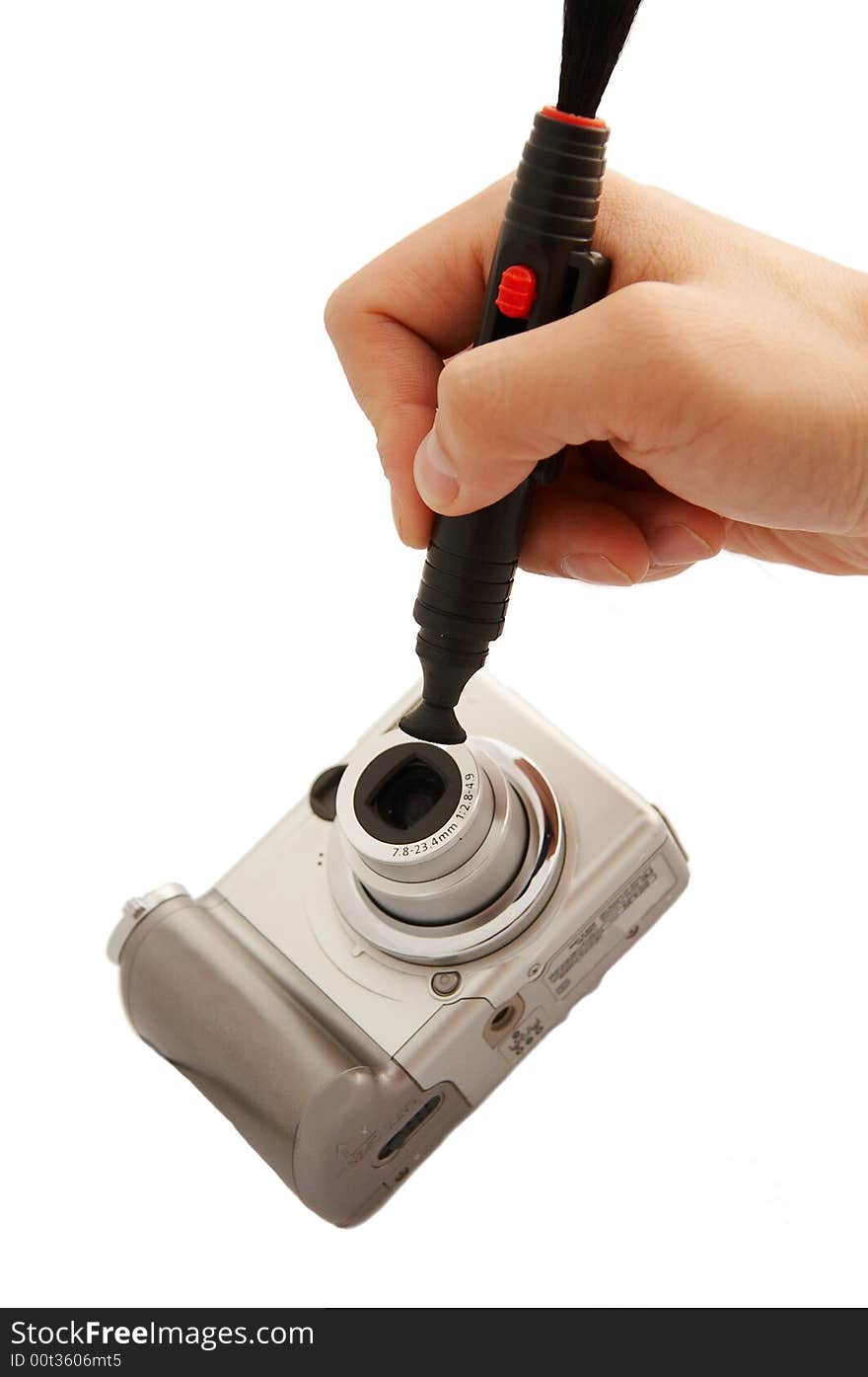 A hand cleaning a lens of camera with a tool,isolated on white. A hand cleaning a lens of camera with a tool,isolated on white