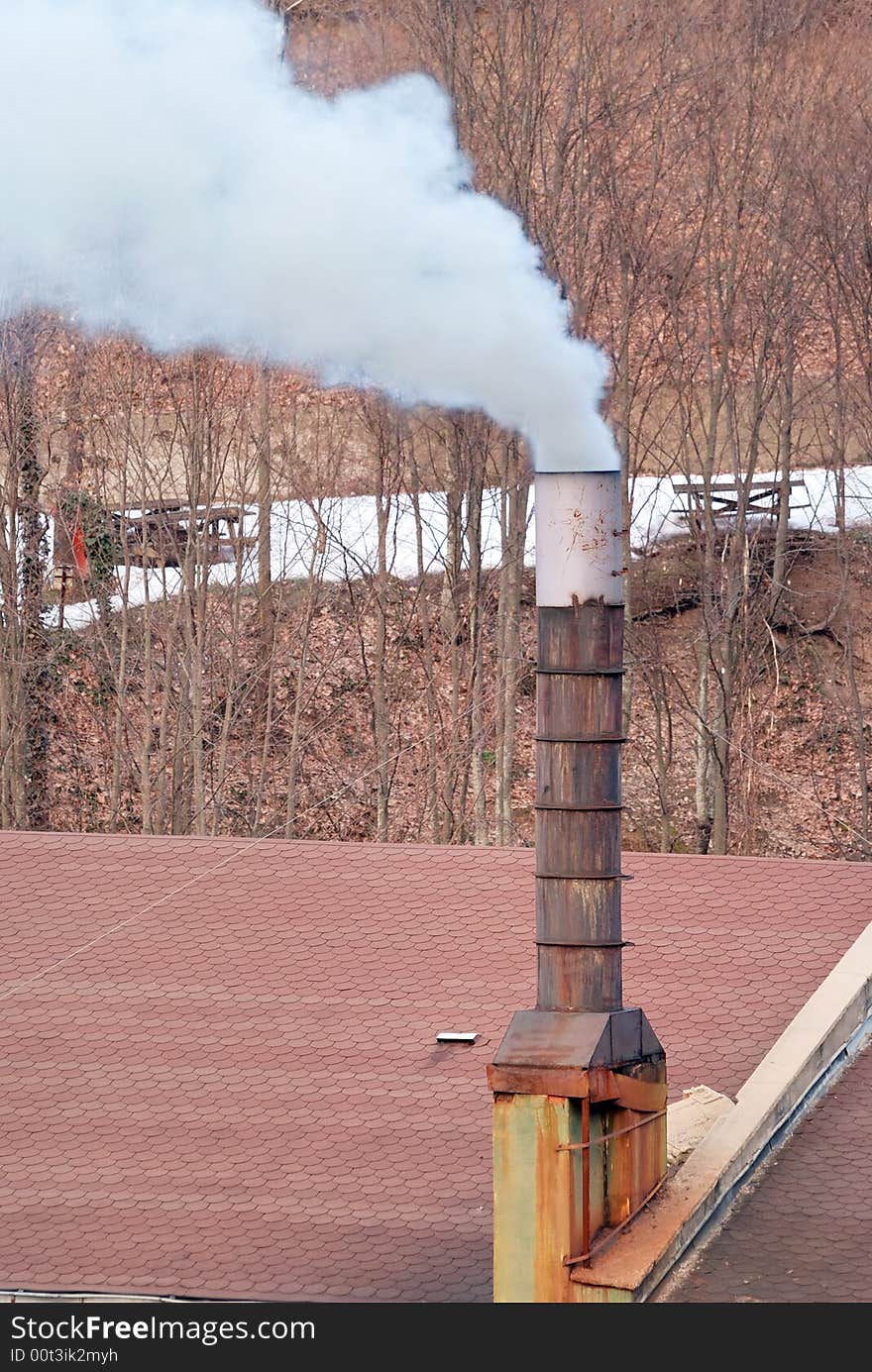 Toxic smoke rising from a chimney in a natural ambient. Toxic smoke rising from a chimney in a natural ambient