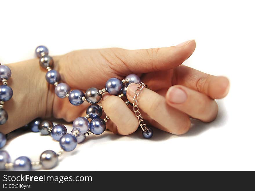 Hand with pearl beads, isolated. Hand with pearl beads, isolated