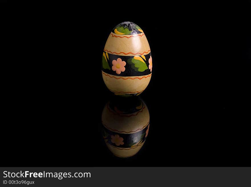 Easter egg on black mirror, hand painted - isolated