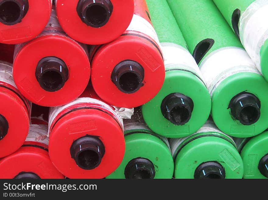 Red and green buoys ashore in a stock