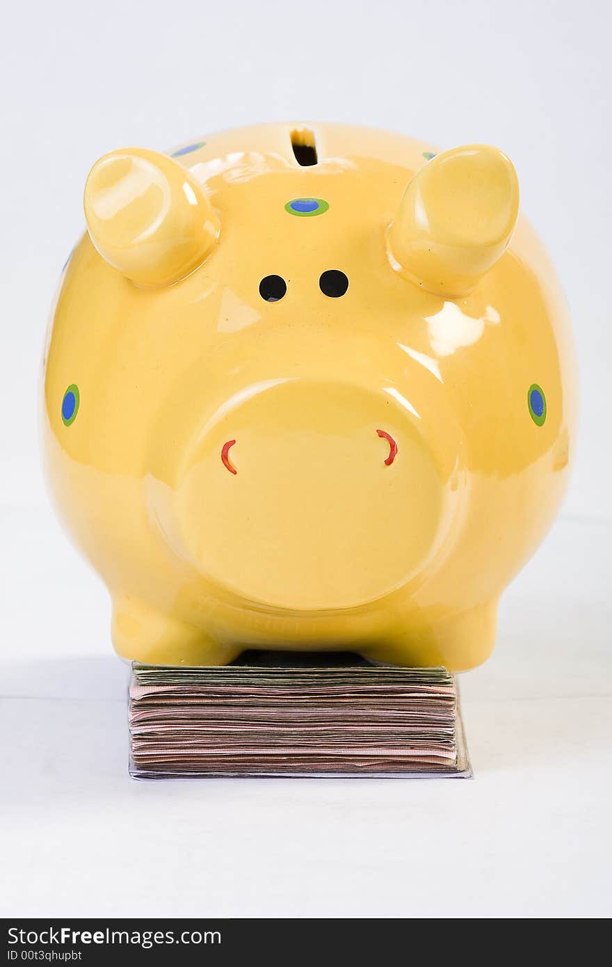 Piggy bank standing on money