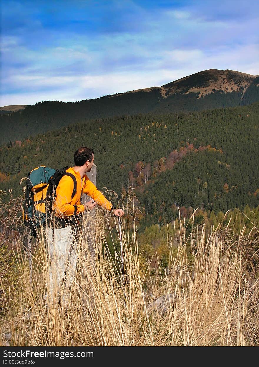 Tourist in Leaota mountains, in a day of october. He look to the peak of Santilia. Tourist in Leaota mountains, in a day of october. He look to the peak of Santilia