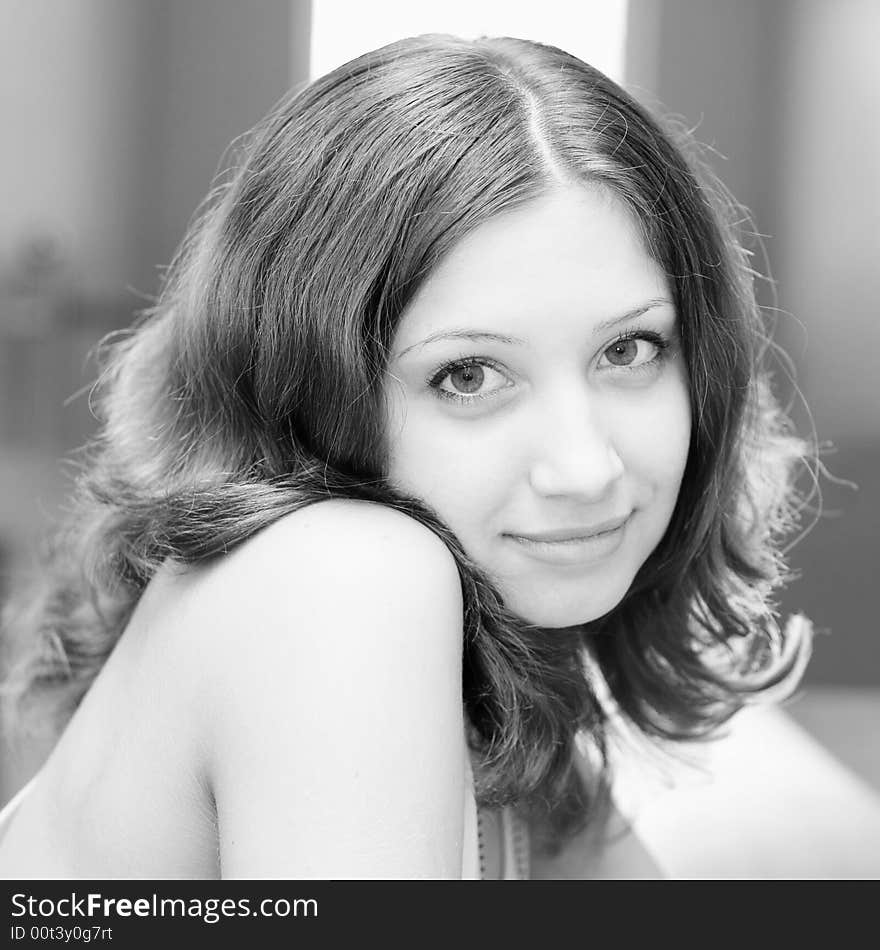 Smiling pretty brunette in a room