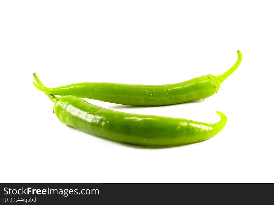 Two green peppers isolatad on white