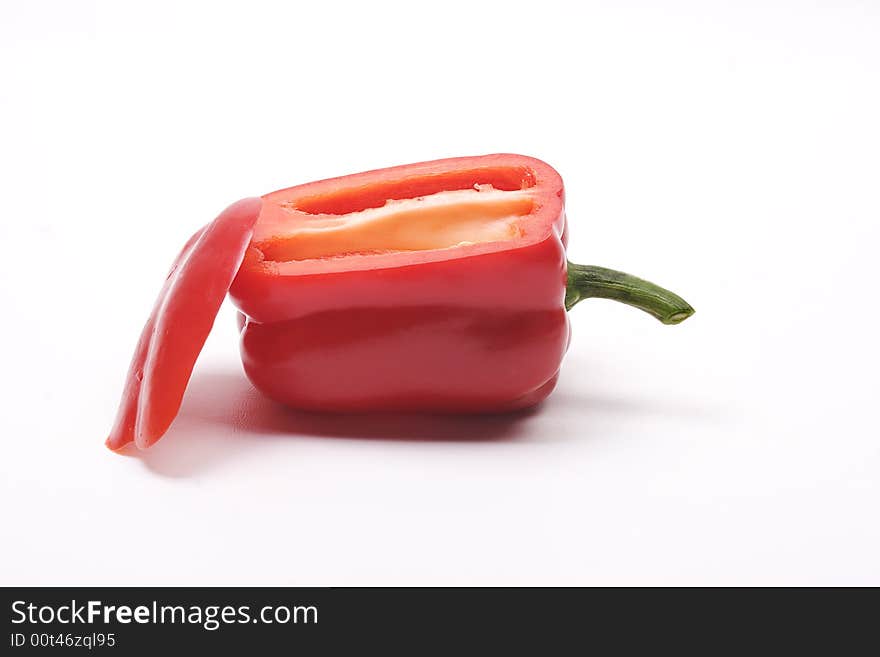 Red bell pepper laying on it's side with it's side sliced off and laying on the end. Red bell pepper laying on it's side with it's side sliced off and laying on the end.