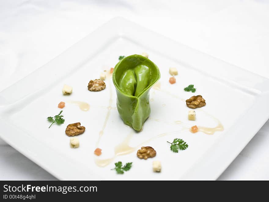 Home made lasagna verde tortellini being created and plated in professional kitchen. Home made lasagna verde tortellini being created and plated in professional kitchen