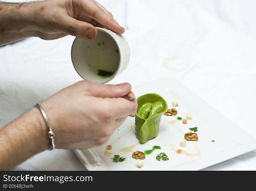 Home made lasagna verde tortellini being created and plated in professional kitchen. Home made lasagna verde tortellini being created and plated in professional kitchen