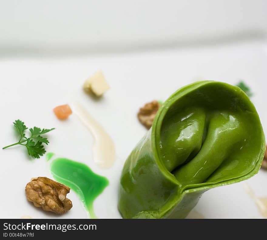 Home made lasagna verde tortellini being created and plated in professional kitchen. Home made lasagna verde tortellini being created and plated in professional kitchen