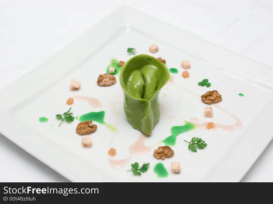 Home made lasagna verde tortellini being created and plated in professional kitchen. Home made lasagna verde tortellini being created and plated in professional kitchen.