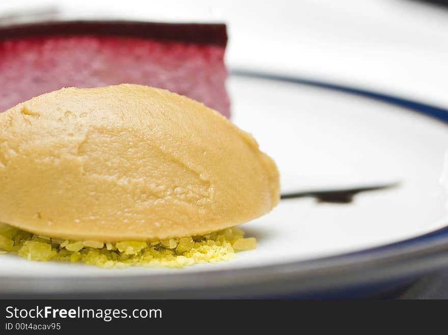 Cool high key macro crop shot of a black currant mousse with liqorice jelly and sorbet. Cool high key macro crop shot of a black currant mousse with liqorice jelly and sorbet