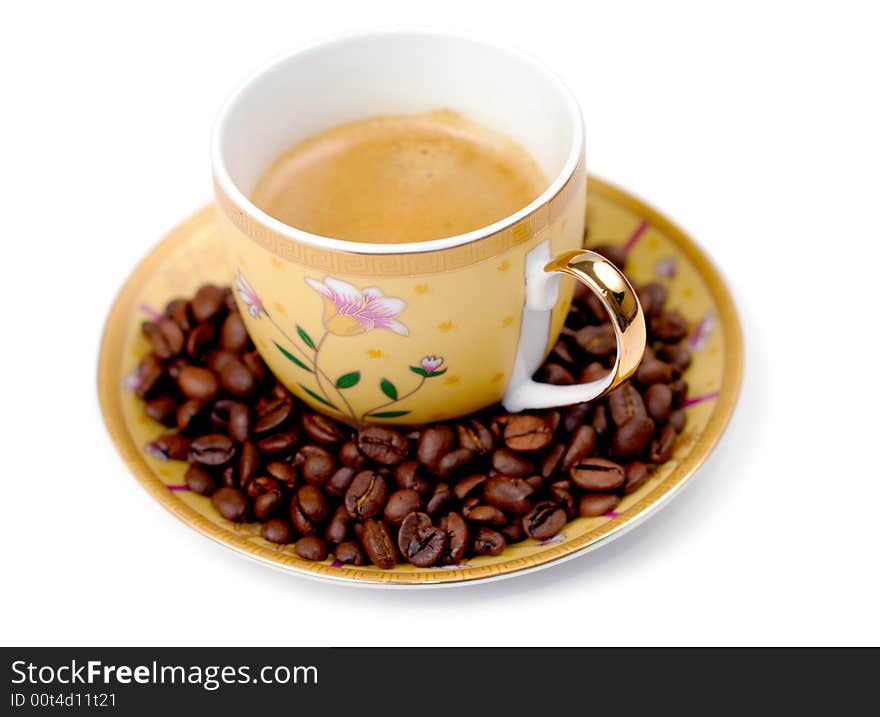 The cup of coffee and beans isolated over white