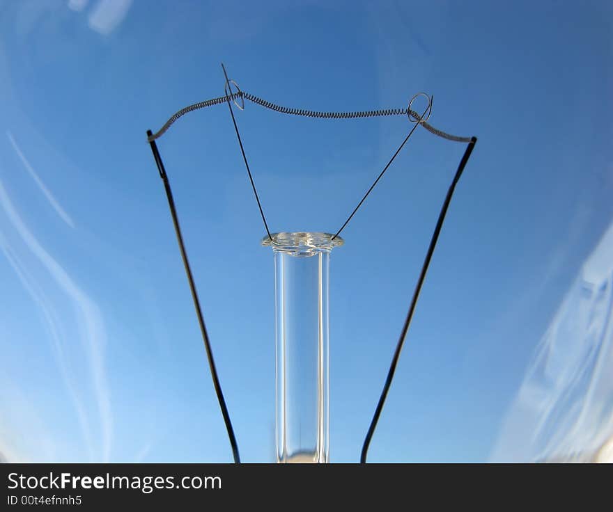 Clear light bulb as idea against blue sky. Clear light bulb as idea against blue sky