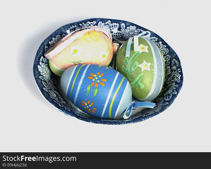 Three colored Easter eggs in decorative plate