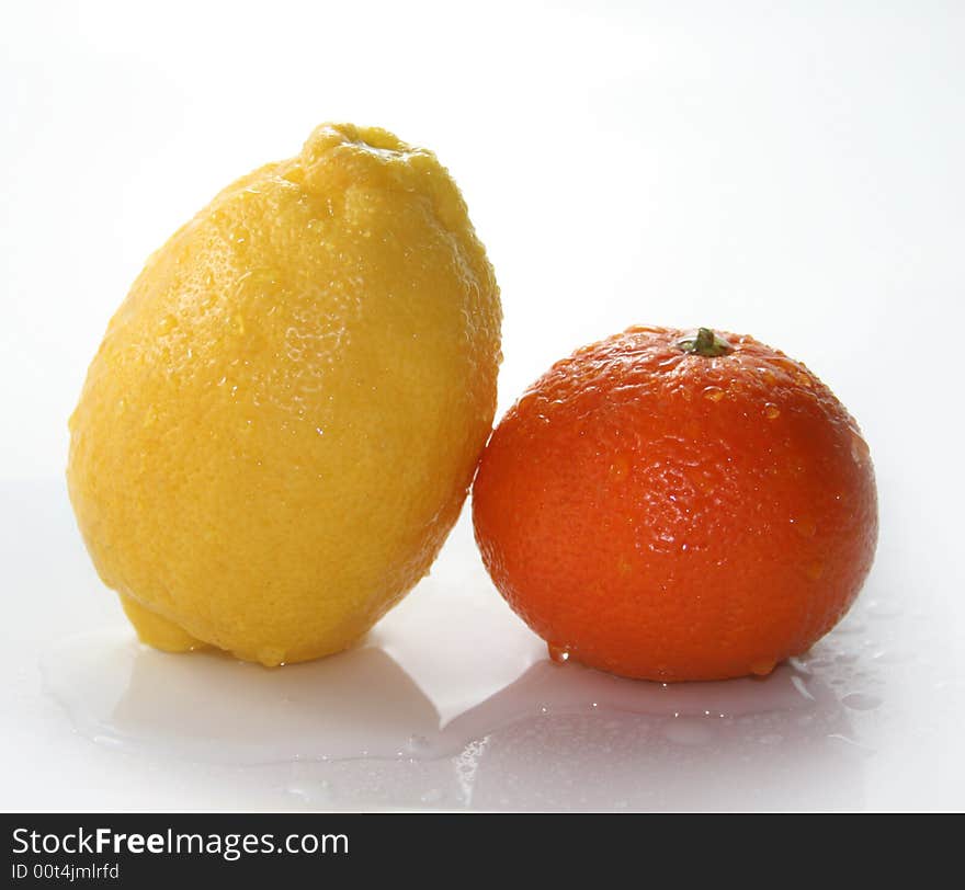 Lemon and tangerine on a white background. Lemon and tangerine on a white background