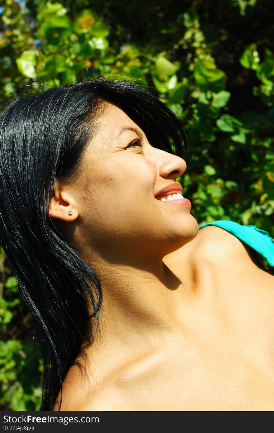 Attractive Woman Smiling with greenery in the Background. Attractive Woman Smiling with greenery in the Background.