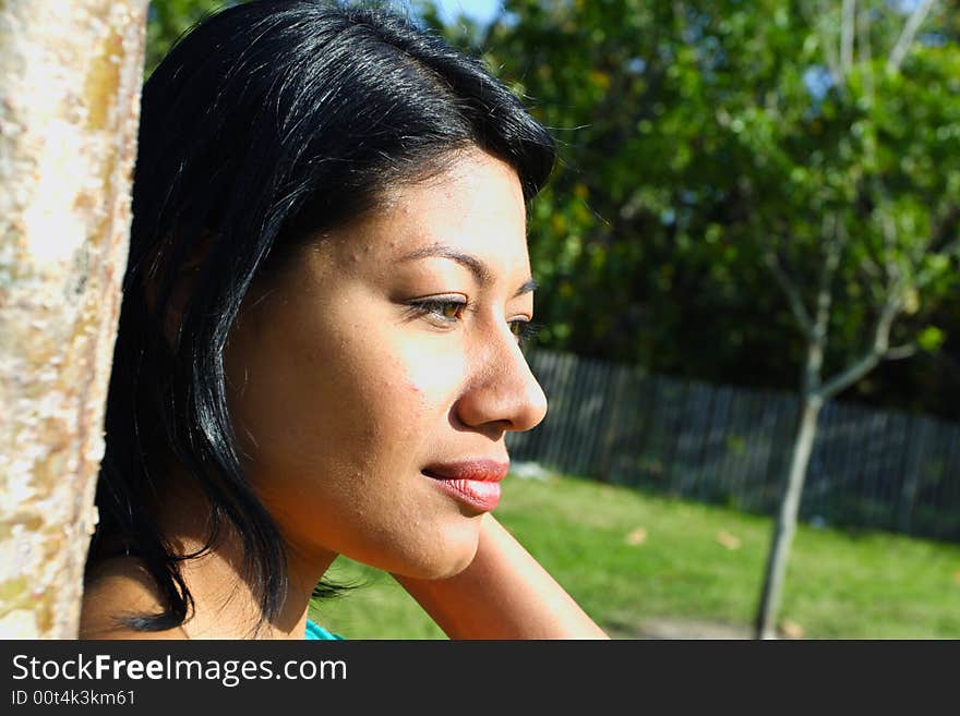 Attractive woman's face lit by the sun