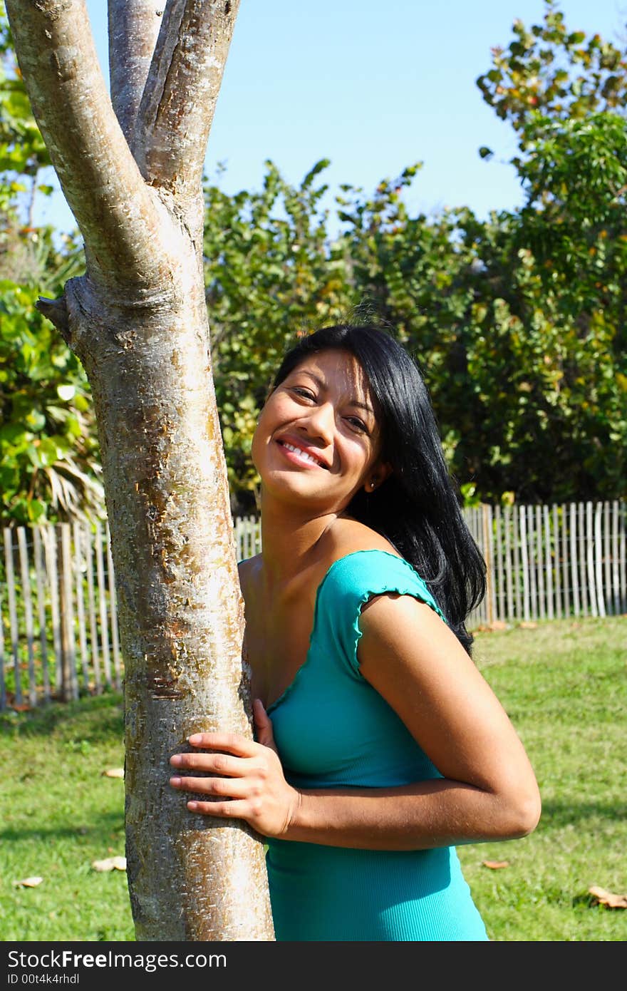 Woman Leaning on a tree at the park