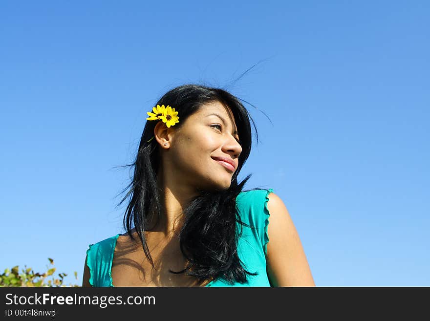 Womans head on a blue sky background. Womans head on a blue sky background