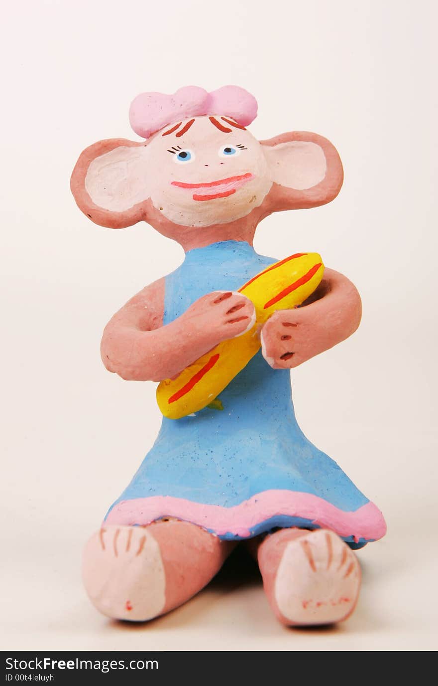 A terracotta fgurine of monkey with banana