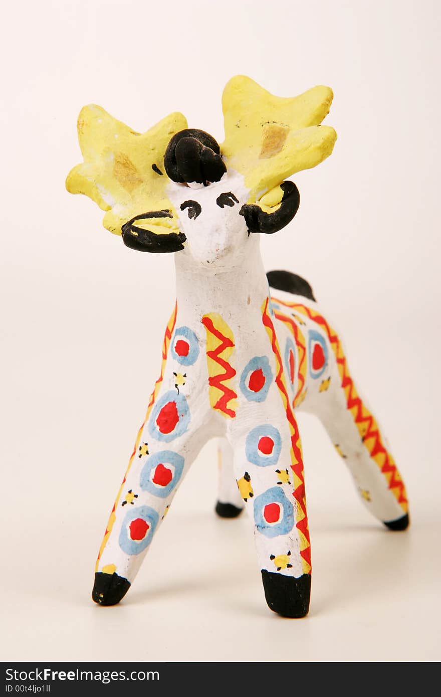 A painted clay statuette of male deer. A painted clay statuette of male deer