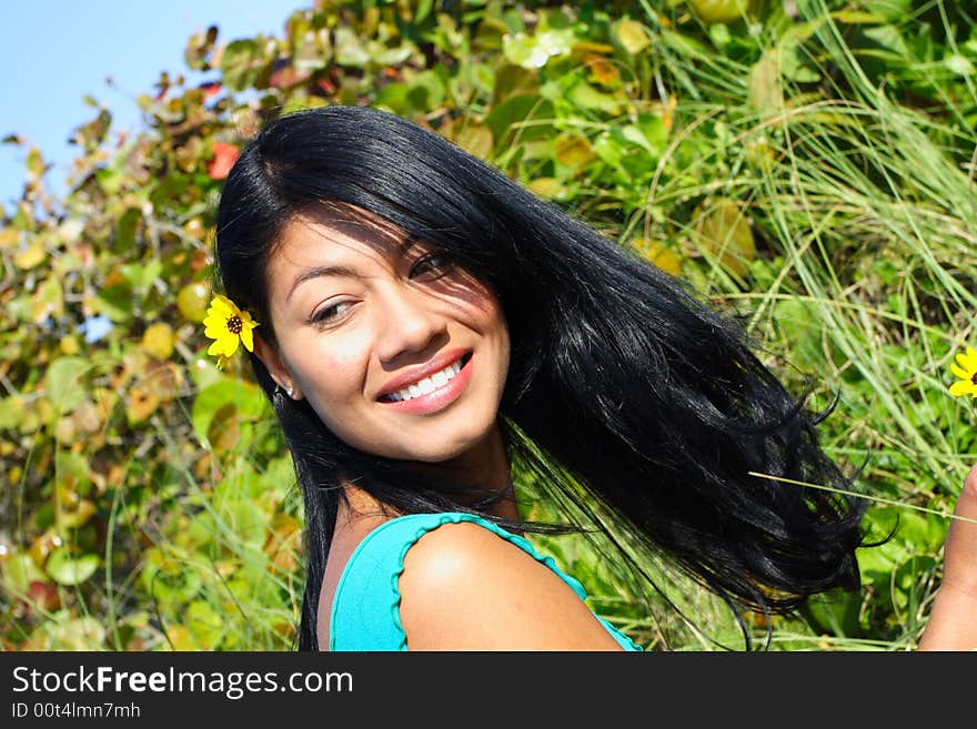 Attractive Woman Smiling with greenery in the Background. Attractive Woman Smiling with greenery in the Background.