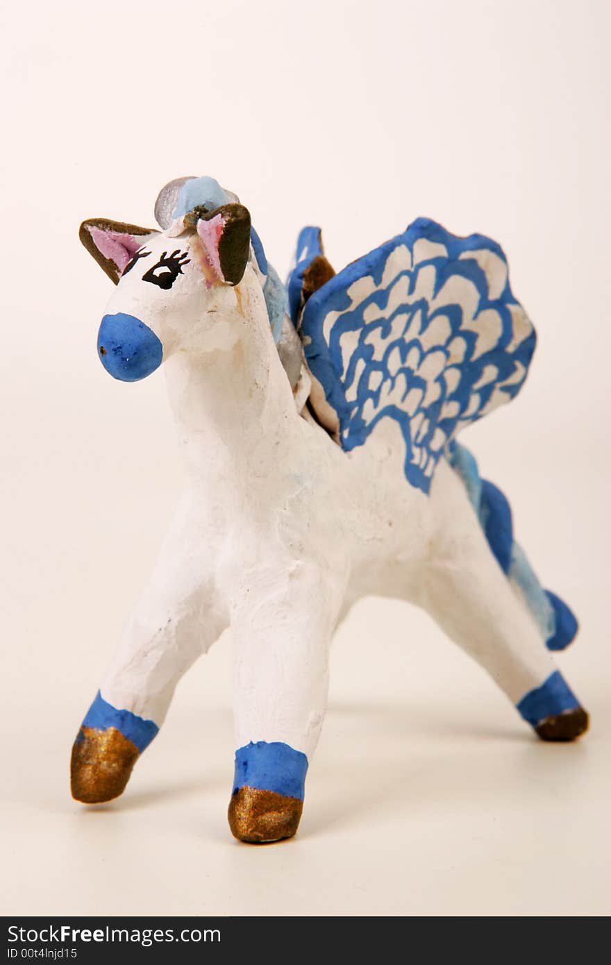 A painted clay figure of fairy winged horse. A painted clay figure of fairy winged horse