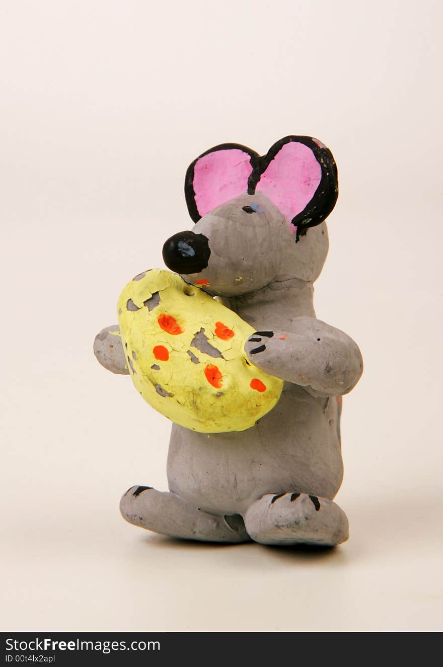 A terracotta figurine of a mouse with cheese