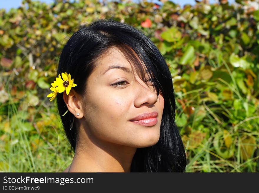 Attractive Woman Smiling with greenery in the Background. Attractive Woman Smiling with greenery in the Background.