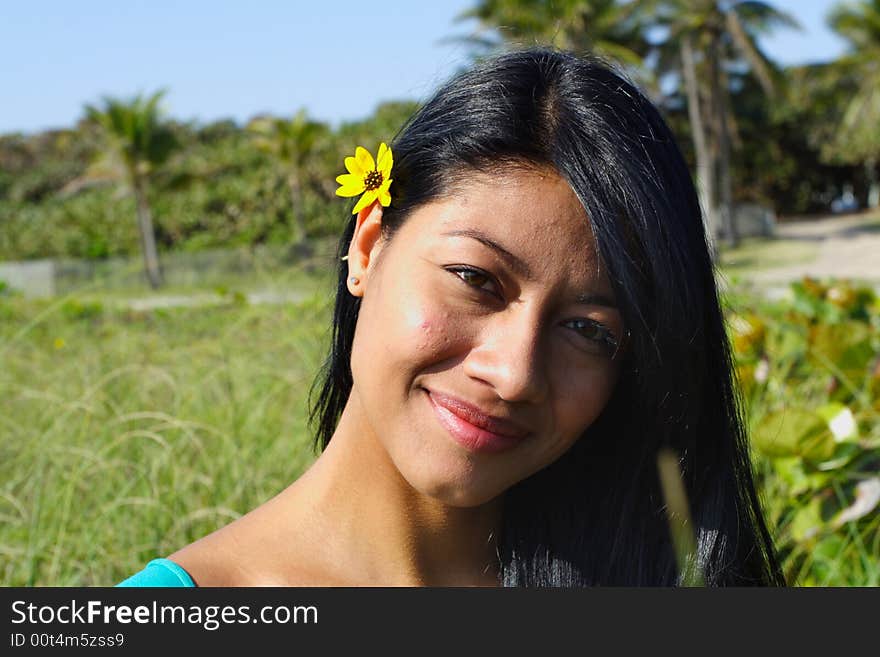 Attractive Woman Smiling with greenery in the Background. Attractive Woman Smiling with greenery in the Background.