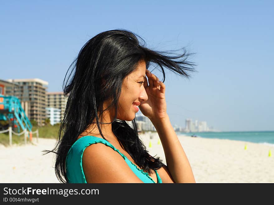 Woman smiling at someone in the water. Woman smiling at someone in the water.