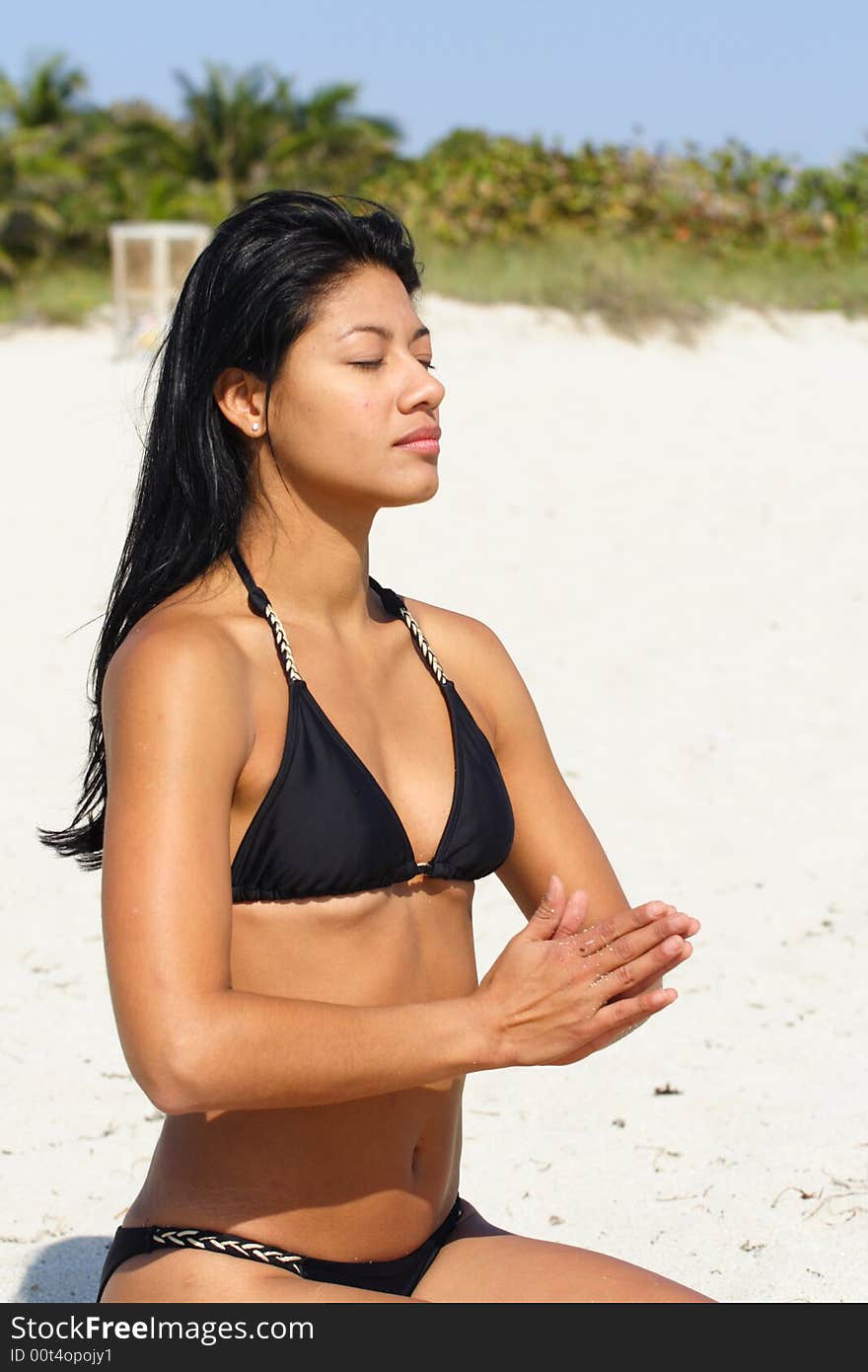 Beautiful young woman on the beach doing yoga exercises. Beautiful young woman on the beach doing yoga exercises.