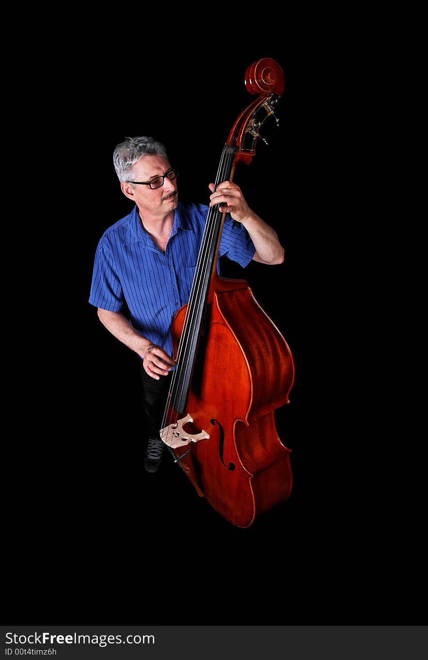 A musician playing a double bass on a black background. A musician playing a double bass on a black background