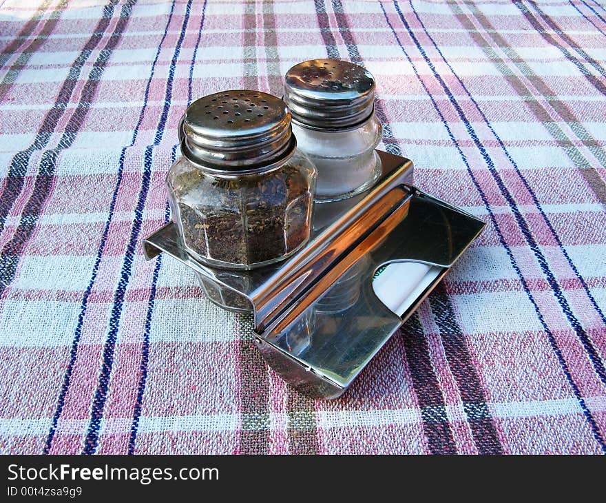 Salt and pepper glass and metal restaurant set. Salt and pepper glass and metal restaurant set