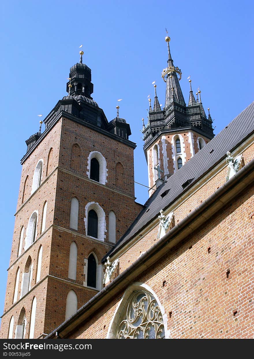 Towers of Cracovian Mariacki church in old city in