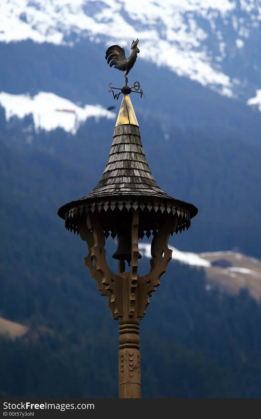 Golden weather vane on the roof in Tirol. Golden weather vane on the roof in Tirol