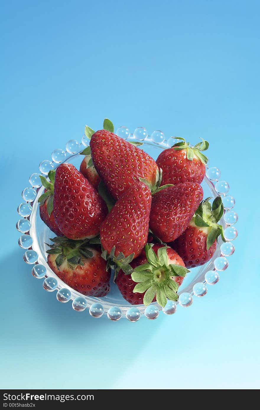 Strawberries fruits cup isolated on blue background. Strawberries fruits cup isolated on blue background