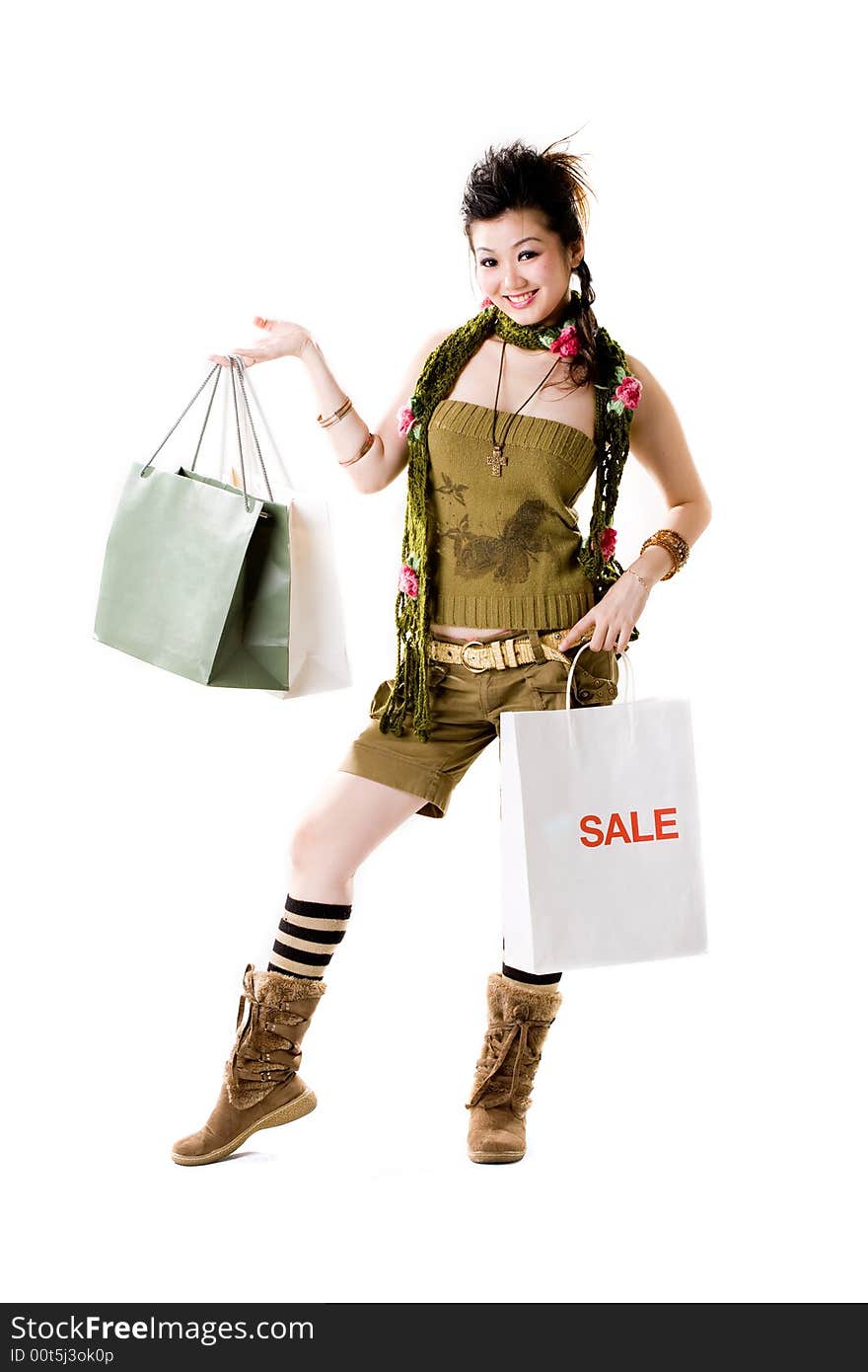 Asian woman happy shopping with hands full of paper bags