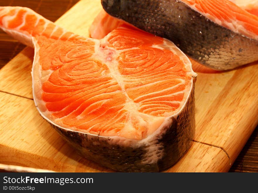 Succulent fresh piece of a salmon on a wooden board