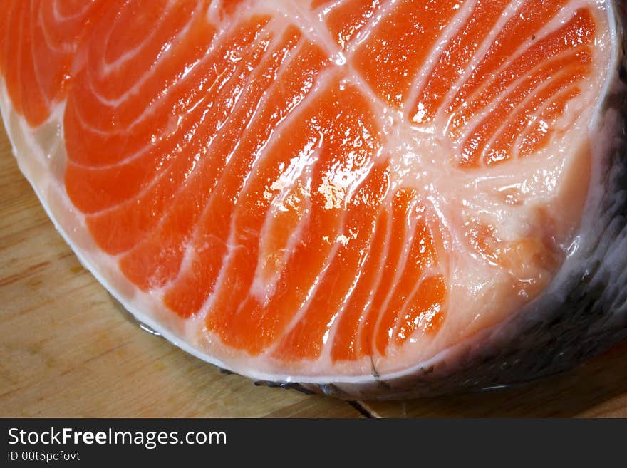 Succulent fresh piece of a salmon on a wooden board