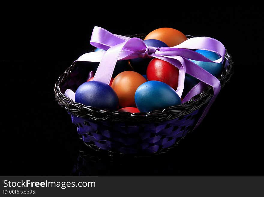 Colored eggs are standing in the basket. Colored eggs are standing in the basket