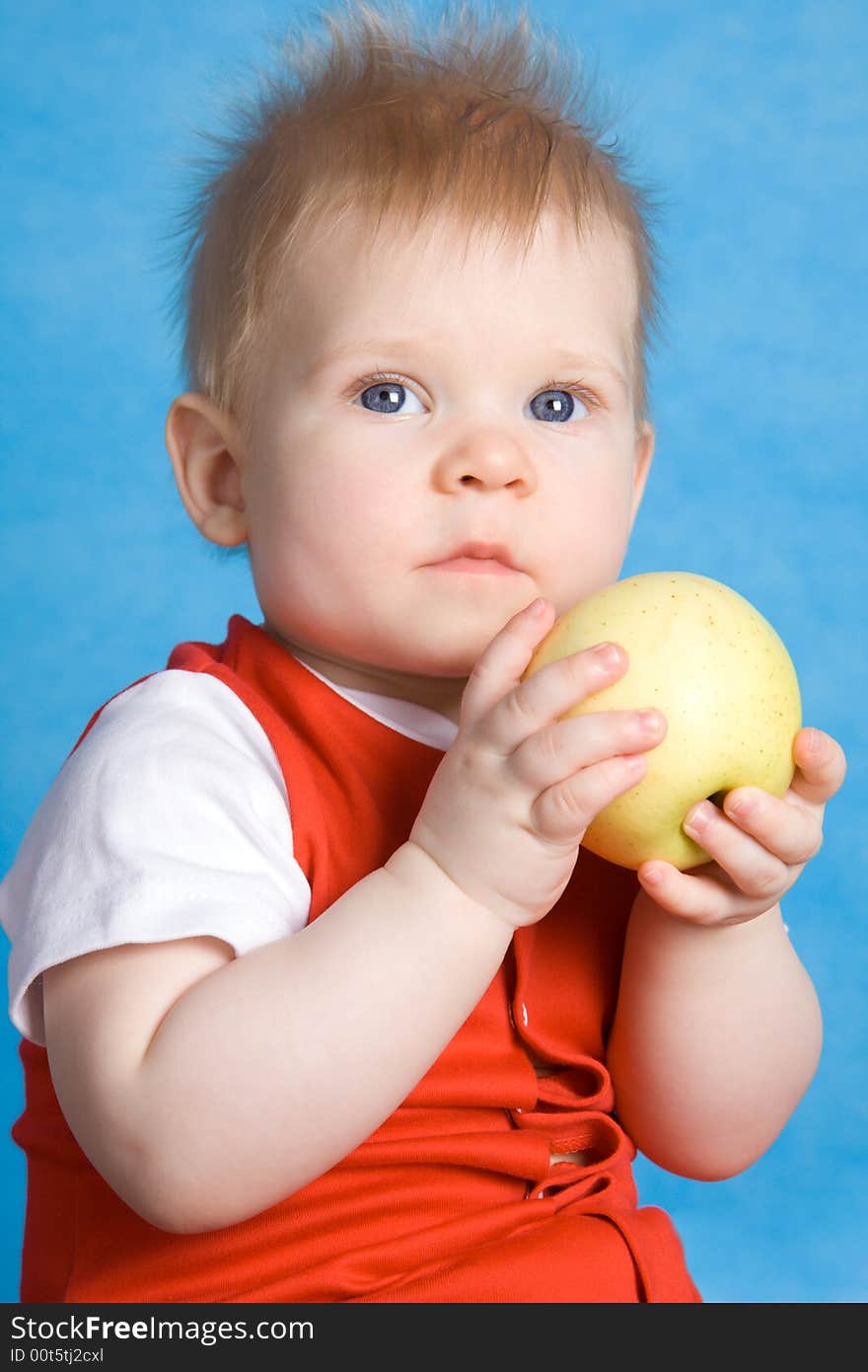 Baby boy eating an apple