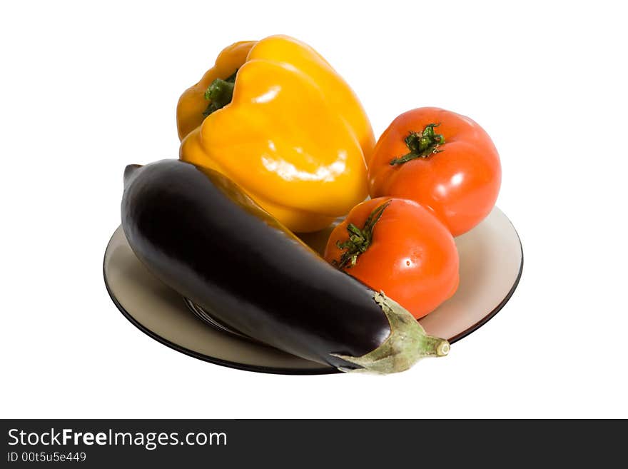 Vegetables on plate isolated on white