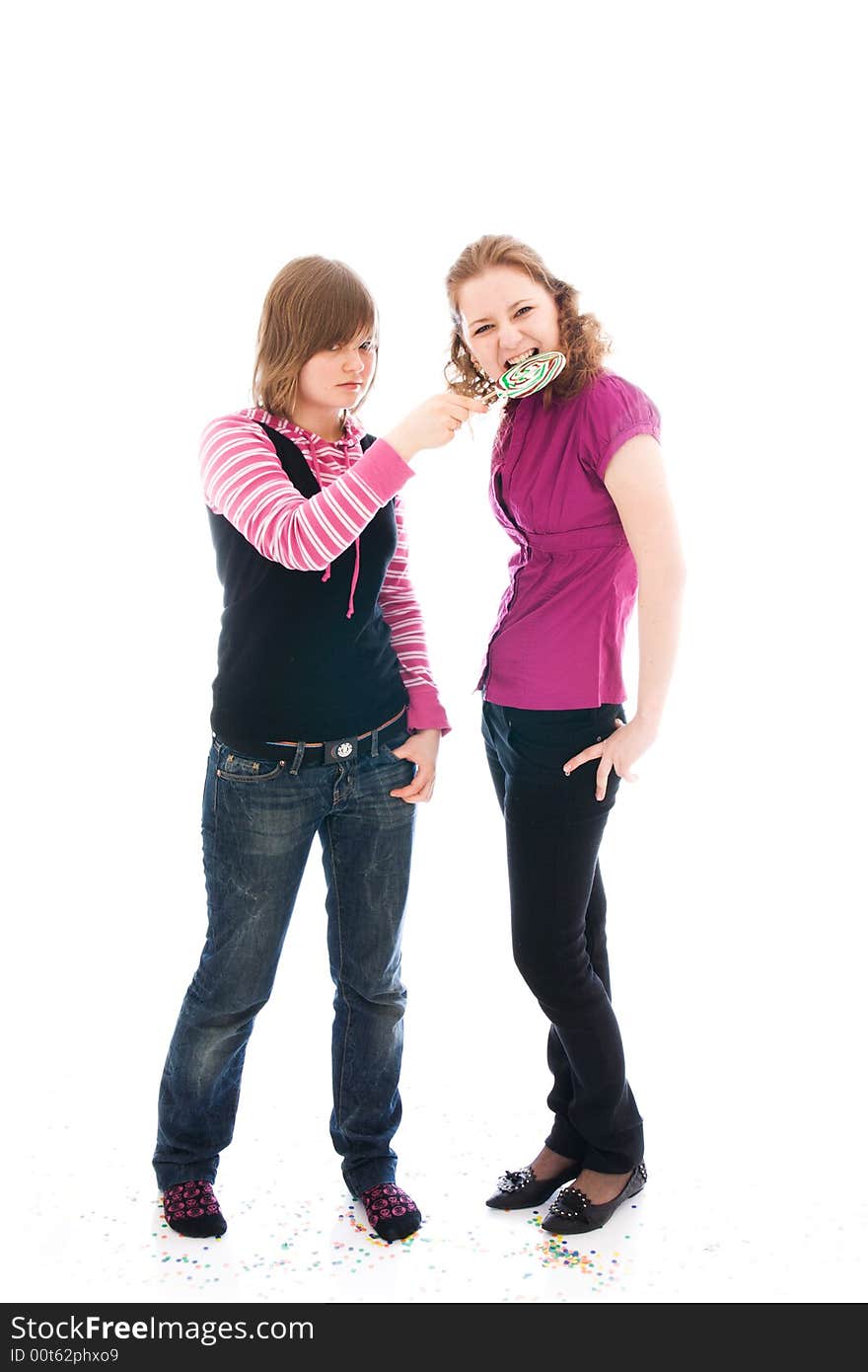 The two girls with a sugar candy isolated on a white background