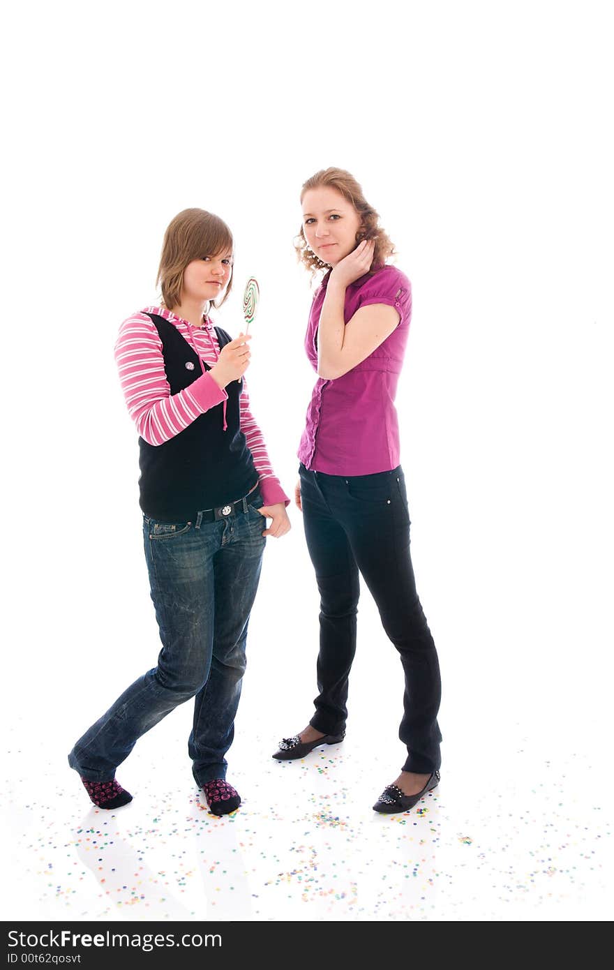 The two girls with a sugar candy isolated on a white background