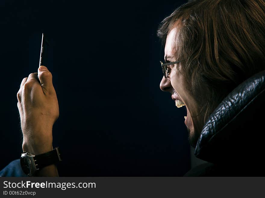 young man screaming at phone