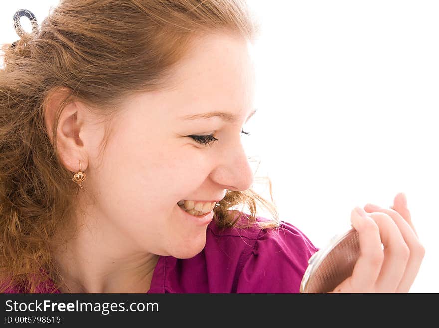 The girl does a make-up isolated on a white