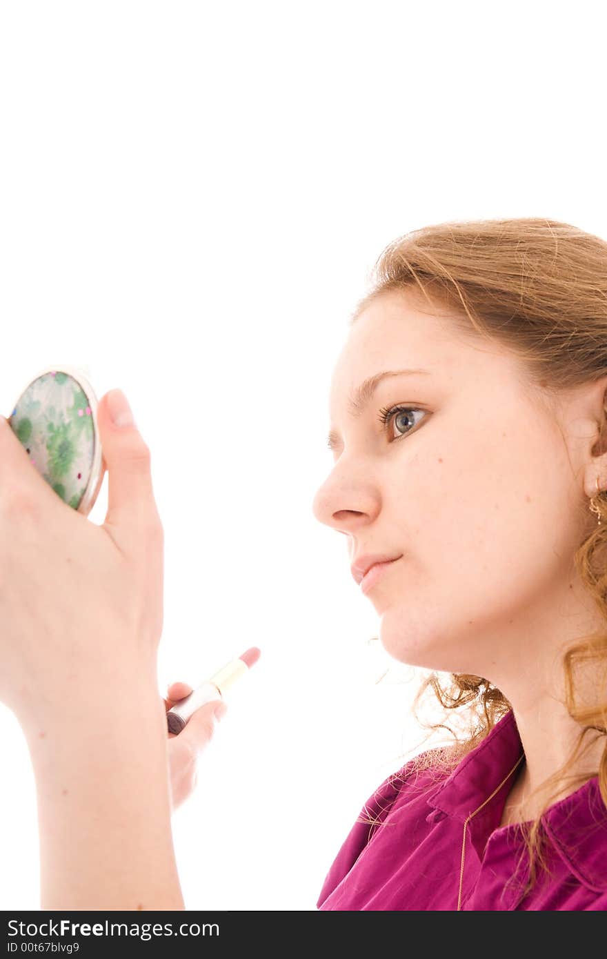 The girl does a make-up isolated on a white