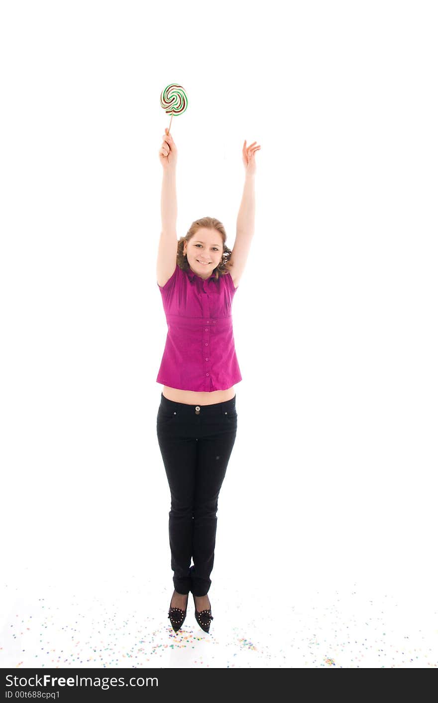 The young jumping girl with a sugar candy isolated on a white background